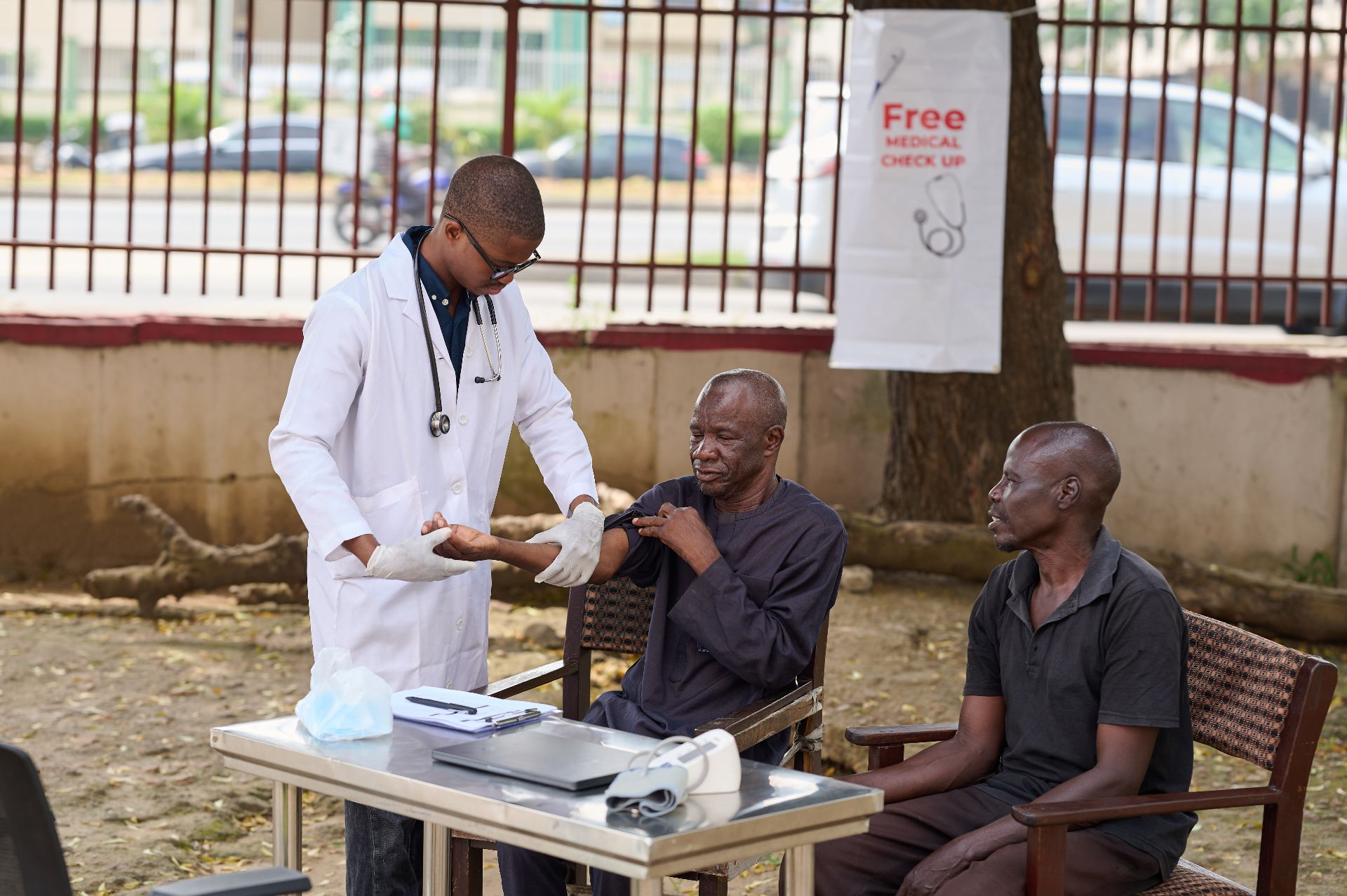 Doctor providing a free medical check-up to a patient at an outdoor clinic