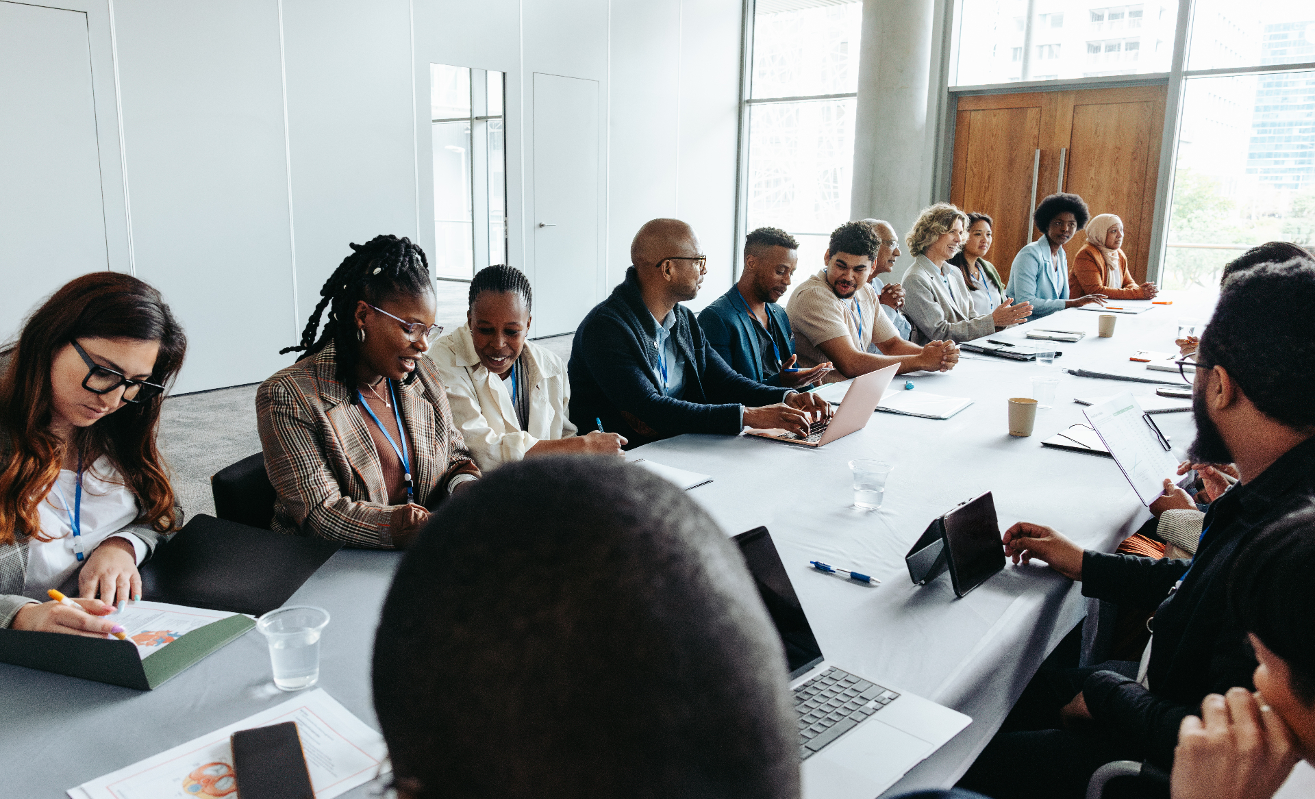 Diverse group of professionals gathered around a boardroom table collaborating
