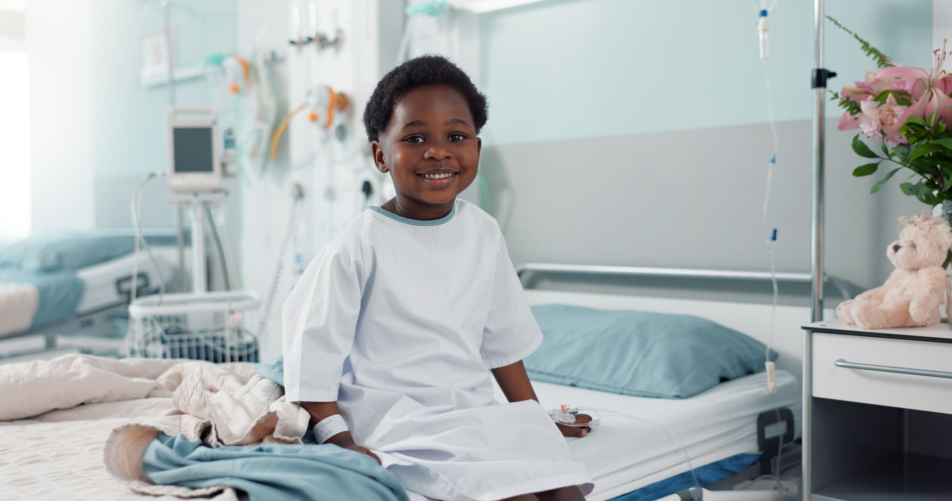 Smiling child patient in a hospital bed